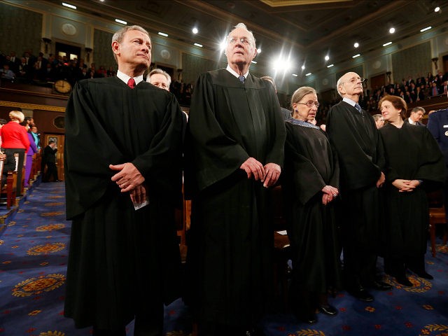 WASHINGTON, DC - JANUARY 28: U.S. Supreme Court Chief Justice John Roberts (L) stands with fellow Justices Anthony Kennedy (2nd from L), Ruth Bader Ginsburg, Stephen Breyer and Elena Kagan (R) prior to President Barack Obama's State of the Union speech on Capitol Hill on January 28, 2014 in Washington, …