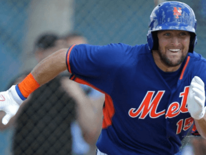 Tim Tebow runs to first base after putting the ball in play during an Instructional League