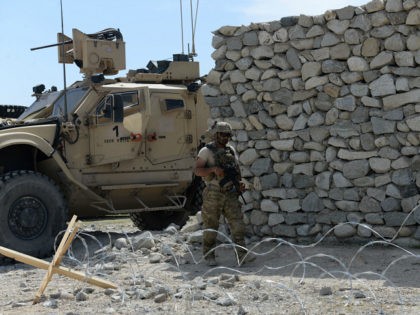 A US soldier patrols near the site of a US bombing during an operation against Islamic State (IS) militants in the Achin district of Nangarhar province on April 15, 2017. Afghan authorities April 15 reported a jump in fatalities from the American military's largest non-nuclear bomb, declaring some 90 Islamic …