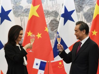 Panama's Foreign Minister Isabel de Saint Malo and Chinese Foreign Minister Wang Yi drink a toast after signing a joint communiqué on establishing diplomatic relations, in Beijing