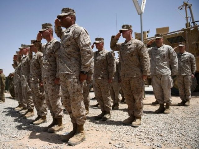 US Marines salute during a handover ceremony at Leatherneck Camp in Lashkar Gah in the Afg
