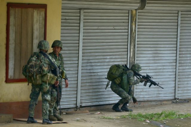 Philippine marines patrol a deserted street in Marawi on June 3, 2017