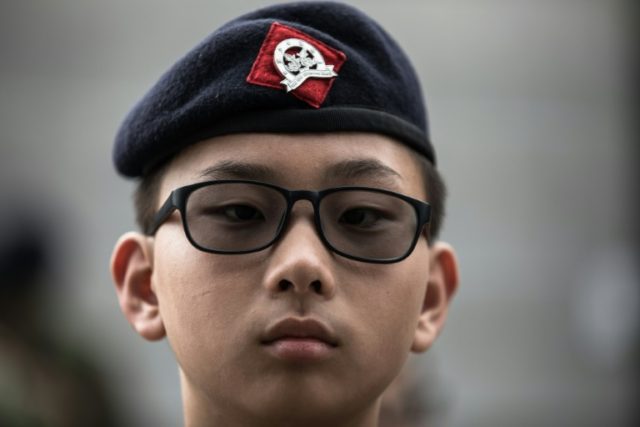 Cadets from the Hong Kong Adventure Corps wear green camouflage and berets and learn every