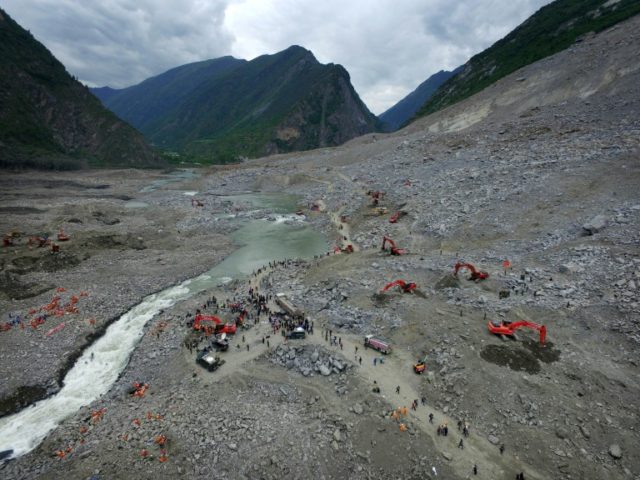 Chinese rescuers search for survivors at a landslide area in the village of Xinmo in Maoxi