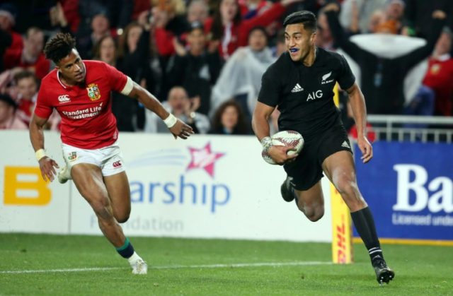 New Zealand All Blacks' Rieko Ioane (R) scores a try in front of Anthony Watson of the Bri