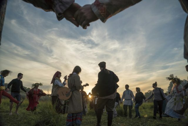 People take part in an ancient pagan ceremony celebrating the summer solstice near the vil