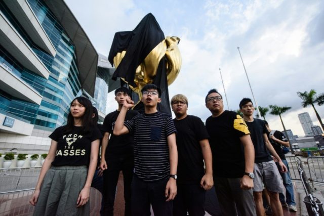 High-profile student campaigner Joshua Wong and a dozen demonstrators attached the black c