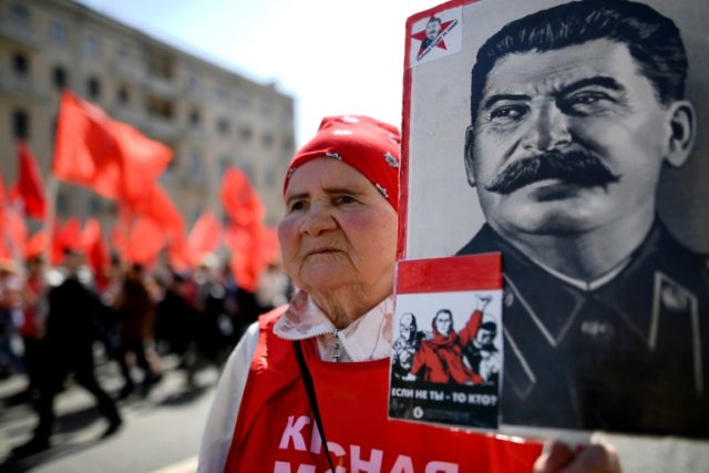 A Russian Communist party activist carries a portrait of late Soviet leader Joseph Stalin
