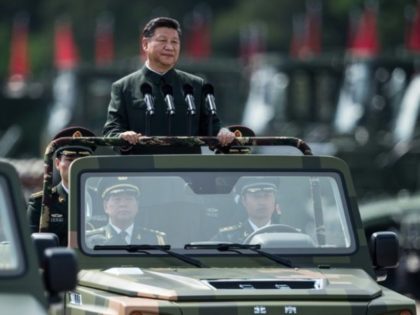 President Xi Jinping wore a Mao suit as he was driven in an open-top jeep past serried ranks of the People's Liberation Army, in a rare show of force in Hong Kong