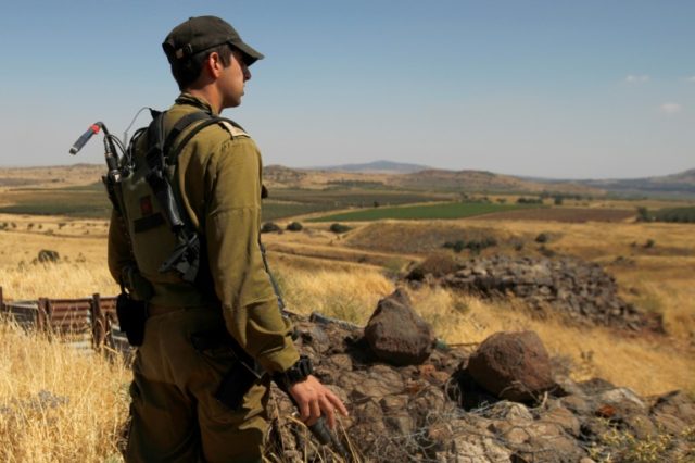 A Israeli soldier on patrol near the border with Syria after projectiles fired from the wa