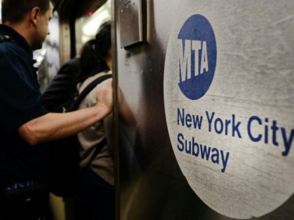 Passengers enter a Metropolitan Transportation Authority (MTA) subway in New York City