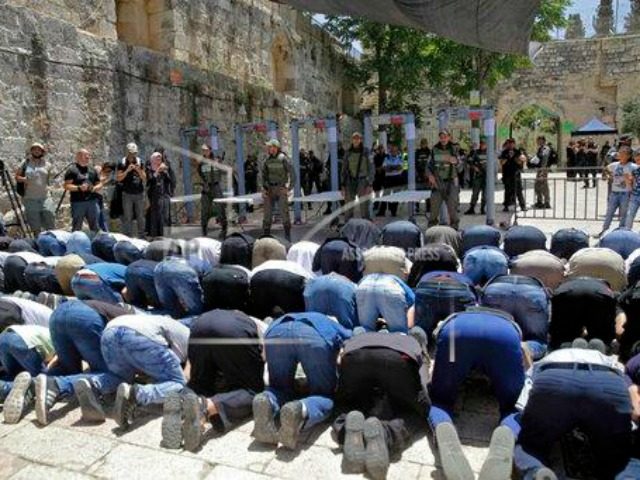 Israeli border police officers stand guard as Muslim men pray outside the Al Aqsa Mosque compound, in Jerusalem Sunday, July 16, 2017. Hundreds of Muslim worshippers visited a Jerusalem holy site Sunday after Israel reopened the compound following a rare closure in response to a deadly shooting last week that …
