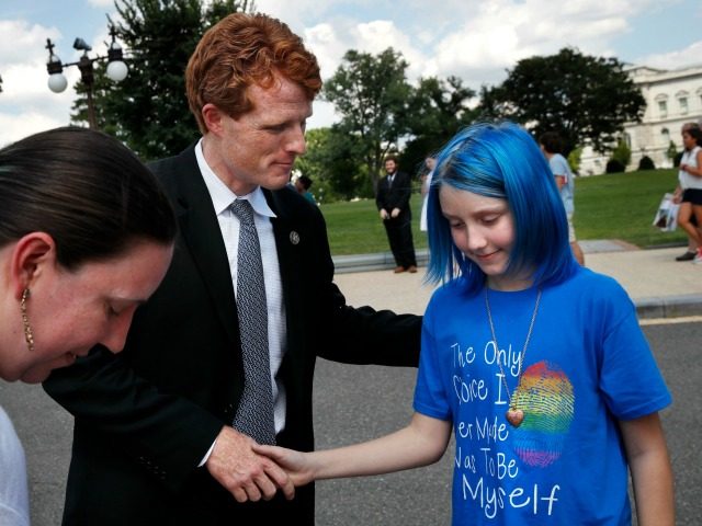 Rep. Joe Kennedy, D-Mass., center, shakes hands with an 11-year-old boy who goes by the name Blue, whose parent is an airman at Ramstein Air Base, July 26, 2017, on Capitol Hill in Washington.
