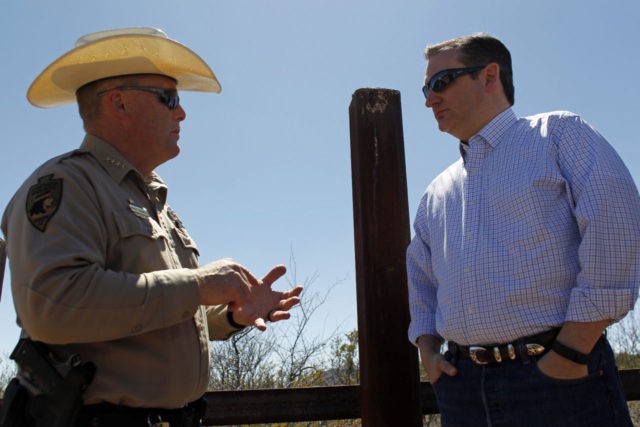 Cochise County Sheriff Mark Dannels speaks with Republican presidential candidate Sen. Ted Cruz, R-Texas, during a visit to the Arizona border with Mexico in Douglas, Ariz., Friday, March 18, 2016. (AP Photo/Ricardo Arduengo)