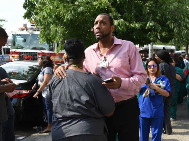 A man reacts outside the Bronx-Lebanon Hospital as police respond to an active shooter New
