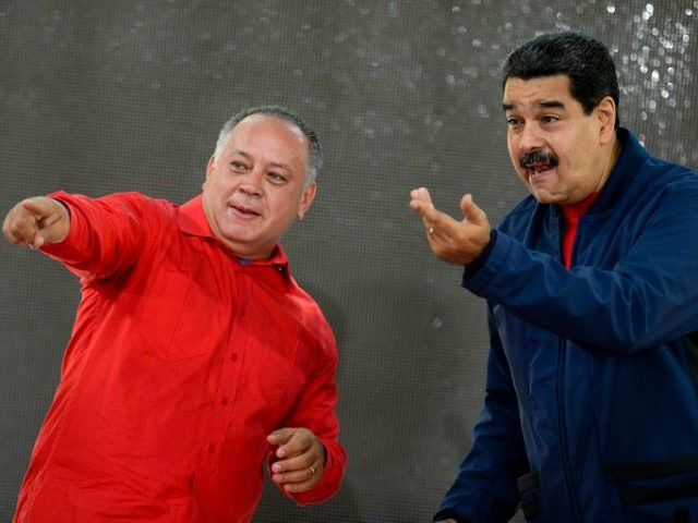 Venezuelan President Nicolas Maduro (R) talks with congressman Diosdado Cabello upon their