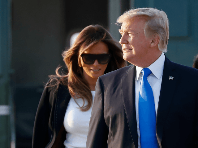 President Donald Trump and first lady Melania Trump walk from Marine One to board Air Forc
