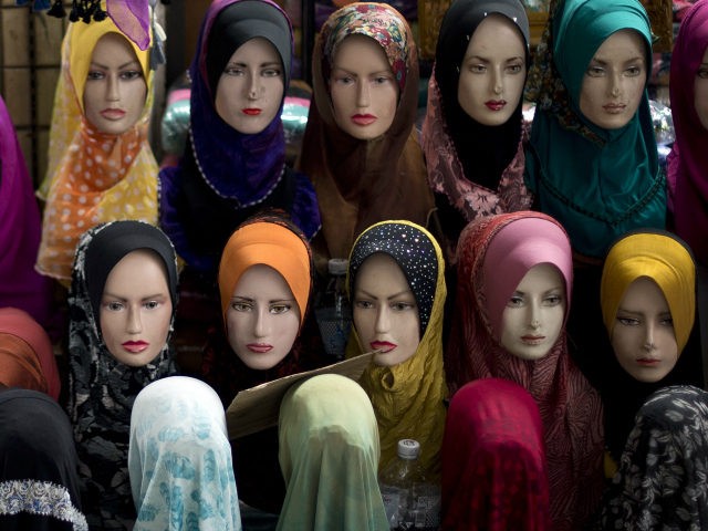 This picture taken on November 30, 2012 shows mannequins with the latest styles of headscarfs or 'hijab' on display outside a shop in downtown Kuala Lumpur. A Malaysian 'hijab', also called a tundung, is a head covering or scarf a woman can wear in public as a symbol of her …