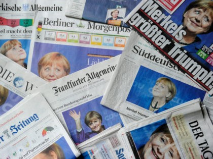 Photos of German Chancellor and Christian Democratic Union (CDU) candidate Angela Merkel are seen on the front pages of German newspapers on September 23, 2013 in Berlin, a day after general elections. Preliminary official results showed that Merkel's CDU and its Bavarian sister party together won 41.5 percent of the …