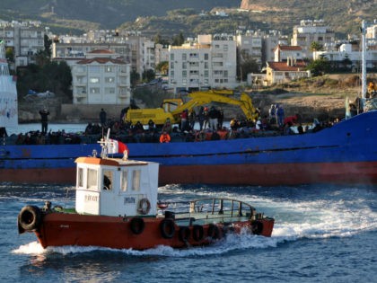 A Turkish Cypriot authority rescue vessel sails towards a fishing boat crammed with some 2