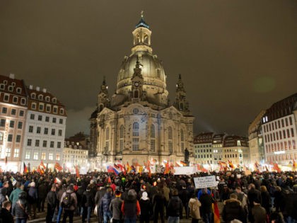 Supporters of the anti-immigrant Pegida movement (Patriotic Europeans Against the Islamisation of the Occident) mark the second year of existence as they demonstrate in Dresden, eastern Germany, on October 2016, and Dresden, a Baroque city in Germany's ex-communist east, is the birthplace of the anti-immigration PEGIDA street movement. / AFP …