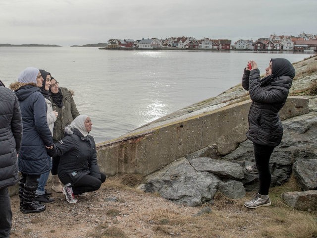 KLADESHOLMEN, SWEDEN - FEBRUARY 10: Refugee women take pictures by the sea on February 10, 2016 in Kladesholmen, Sweden. Last year Sweden received 162,877 asylum applications, more than any European country proportionate to its population. According to the Swedish Migration Agency, Sweden housed more than 180,000 people in 2015, more …