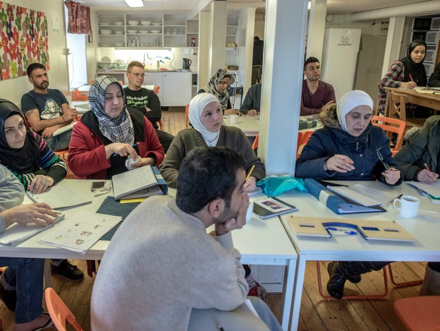 KLADESHOLMEN, SWEDEN - FEBRUARY 10: Refugees attend to Swedish language class at the temporary house for asylum seekers of the Vattendroppen school on February 10, 2016 in Kladesholmen, Sweden. Last year Sweden received 162,877 asylum applications, more than any European country proportionate to its population. According to the Swedish Migration …