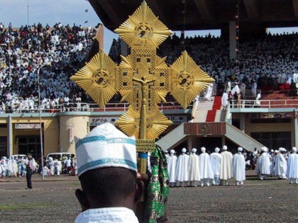 ASMARA, ERITREA: An Orthodox priest holds a cross during the Meskel festival, the biggest Orthodox ceremony, 27 September 2004 in Asmara in Eritrea. Thousands of people gather each year in the Eritrean capital to celebrate the finding of Christ's cross by Saint Helen, some 1700 years ago. AFP PHOTO NICOLAS …