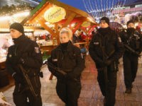 BERLIN, GERMANY - DECEMBER 22: Heavily-armed police walk through the reopened Breitscheidplatz Christmas market where three days ago a truck plowed into the market, killed 12 people and injured dozens in a terrorist attack on December 22, 2016 in Berlin, Germany. The Breidscheidplatz Christmas market is reopening today, though its …