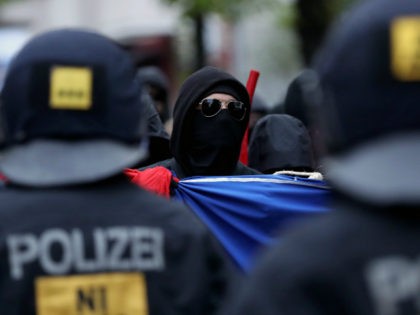 BERLIN, GERMANY - MAY 01: A leftist demonstrator faces riot police during the 'Revolutionary 1st of May' May Day protest in Kreuzberg district on May 1, 2017 in Berlin, Germany. Labour unions and leftists each had their own marches across the city today and thousands of revelers celebrated at the …