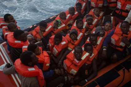 LAMPEDUSA, ITALY - JUNE 10: Refugees and migrants wait to be transfered onboard the Migran