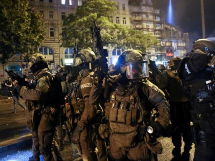 A police special commandos unit SEK patrol during riots on July 7, 2017 in Hamburg, northern Germany, where leaders of the world's top economies gather for a G20 summit. Protesters clashed with police and torched patrol cars in fresh violence ahead of the G20 summit, police said. German police and …