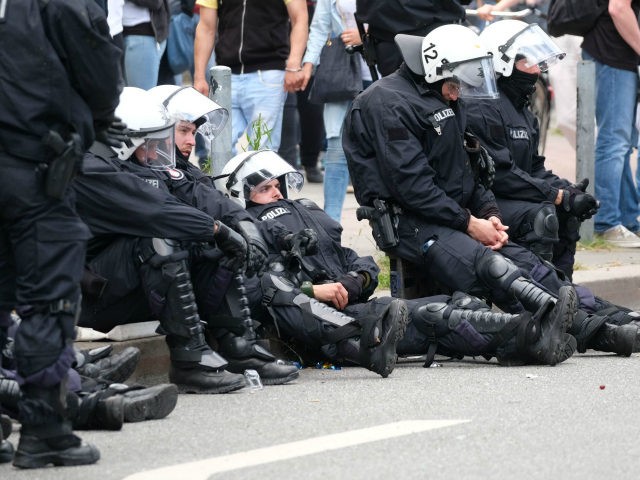 Police rest during a demonstration on July 8, 2017 in Hamburg, northern Germany as world leaders meet during the G20 summit. Raging street battles that marred Germany's G20 summit have sparked a political fight over how Hamburg could descend into 'mob rule' and why Chancellor Angela Merkel chose a hotbed …