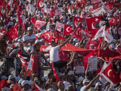 ISTANBUL, TURKEY - JULY 09: Thousands of supporters cheer and wave flags while listening