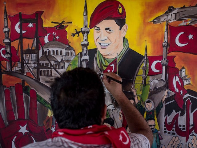 ISTANBUL, TURKEY - JULY 12: A man puts the finishing touches on a painting depicting the events of the July 15, 2016 coup attempt at an anniversary site setup to mark the first anniversary of the failed coup attempt in Taksim square on July 12, 2017 in Istanbul, Turkey. July …