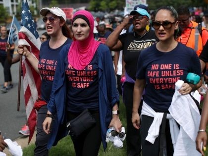 Activist Linda Sarsour (C) and fellow gun-control activists participate in a march beginning at the headquarters of National Rifle Association July 14, 2017 in Fairfax, Virginia. Women's March holds a two-day rally and march from the NRA headquarters to the Justice Department in Washington, DC, to protest the association's 'incendiary …