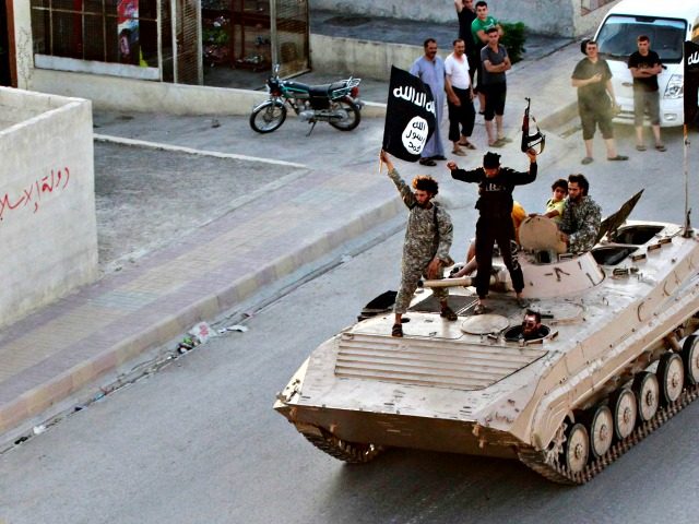 ISIS Islamic militants riding a Soviet-built BMP personnel carrier in Iraq.