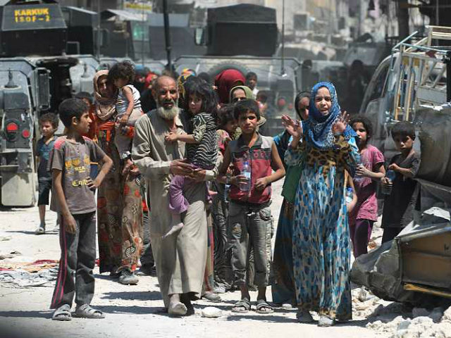 Iraqis flee from the Old City of Mosul on July 5, 2017, during the Iraqi government forces