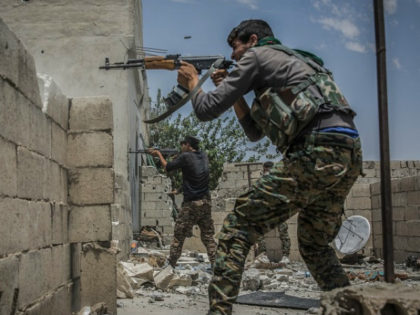 Fighters of the People's Protection Units (YPG), a mainly-Kurdish militia in Syria, fires