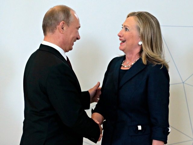 Putin, Hillary Mikhail MetzelAP