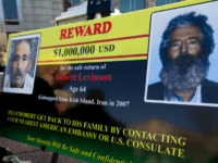 In this March 6, 2012 file photo, an FBI poster showing a composite image of former FBI agent Robert Levinson, right, of how he would look like now after five years in captivity, and an image, left, taken from the video, released by his kidnappers, in Washington during a news …