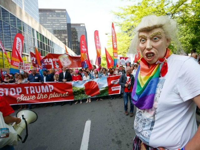 A protester wears a Donald Trump mask mask during a demonstration againt the US president in Brussels on May 24, 2017