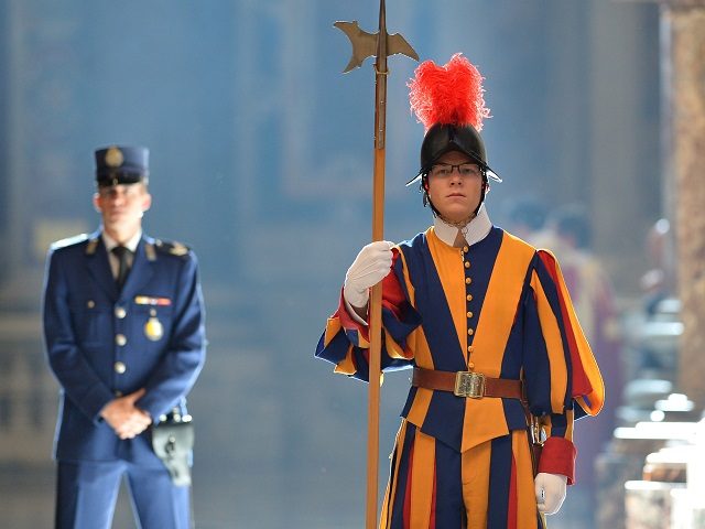 A Swiss guard stands during a papal mass for Cardinals and Bishops who died in the year at