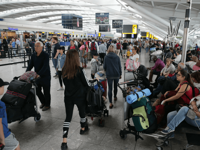 Passengers arrive with their luggage in Terminal 5 of London's Heathrow Airport on Ma