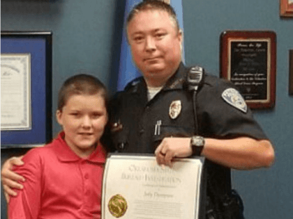 Police officer Jody Thompson and his adopted son John, 10, who was found tied up and beate