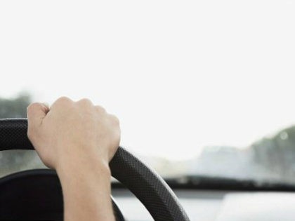 Child's hands on steering wheel