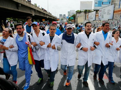Doctors march during an anti-government protest demanding that Venezuelan President Nicola