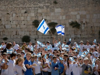 School children wave Israeli flags at the Western Wall, the holiest place where Jews can pray, in Jerusalem's Old City, during Jerusalem Day celebrations, Wednesday, May 24, 2017. On Wednesday Israelis commemorated the capture of the city's eastern sector in the 1967 Mideast war. (AP Photo/Ariel Schalit)