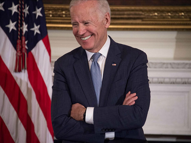 US Vice President Joe Biden laughs as President Barack Obama speaks during a tribute to Biden at the White House in Washington, DC, on January 12, 2017. / AFP / NICHOLAS KAMM (Photo credit should read NICHOLAS KAMM/AFP/Getty Images)