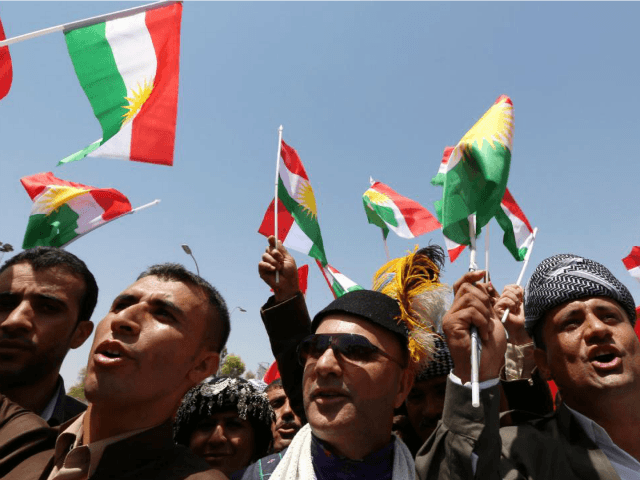 Iraqi Kurdish protesters wave flags of their autonomous Kurdistan region during a demonstration to claim for its independence on July 3, 2014 outside the Kurdistan parliament building in Arbil, in northern Iraq. The Kurdish leader, Massud Barzani asked its parliament to start organizing a referendum on independence. AFP PHOTO / …